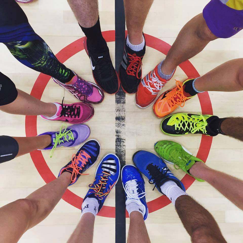 Photo of colourful shoes with rainbow laces in a circle