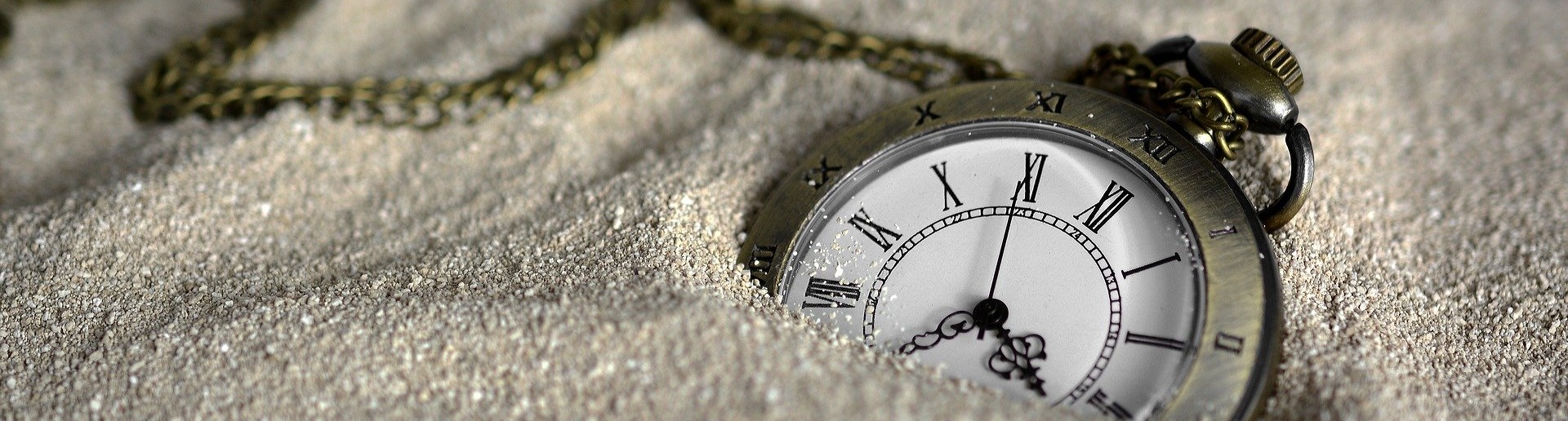 pocket watch in sand