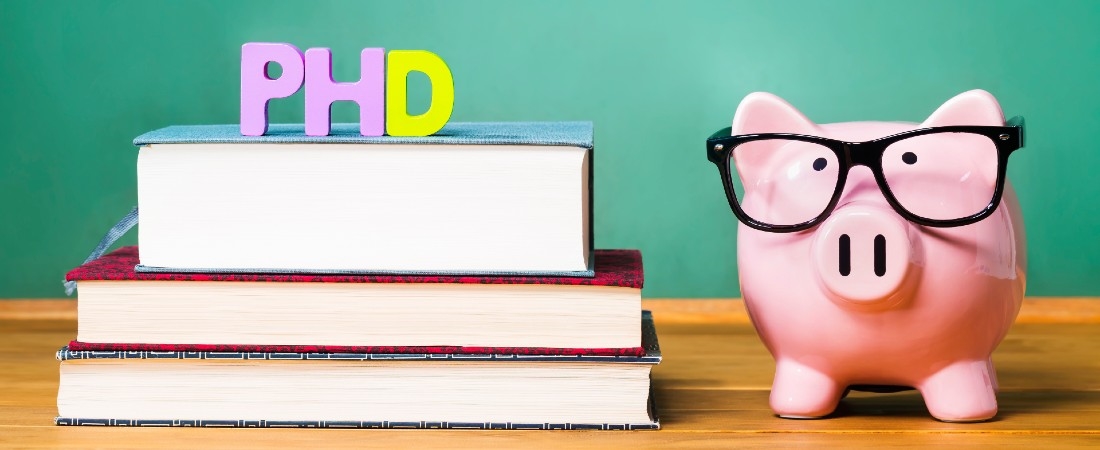 Image of a piggy bank and books with the text 'PhD'